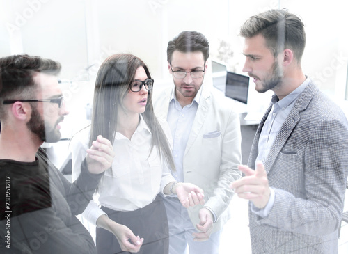 employees discuss business problems standing in the office