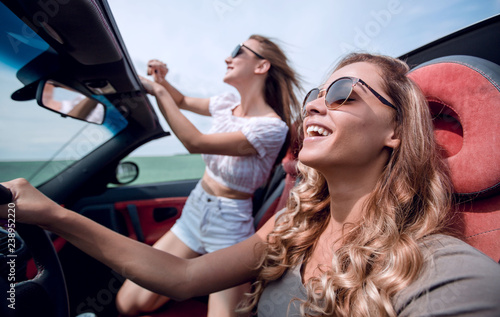 close up.cheerful young women traveling in a convertible © ASDF