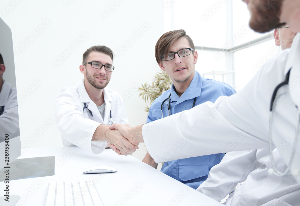 handshake between the two doctors during the working meeting handshake between the two doctors during the working meeting