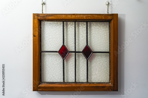 Obraz na plátně Wooden framed English stained glass window with red diamond pattern glass