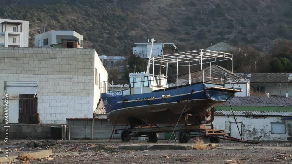 Old Ship Staying in Port. Old boat. it don't work. Rust Metal. it don't work. Ships in Dock. City Buildings on Hill. Summer Day Old Ship Staying in Port. Old boat. it don't work. Rust Metal. it don't work. Ships in Dock. City Buildings on Hill. Summer Day