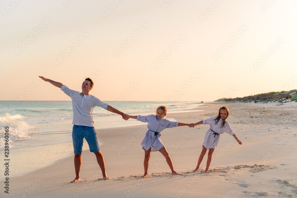 Family walking on white tropical beach on caribbean island Family walking on white tropical beach on caribbean island