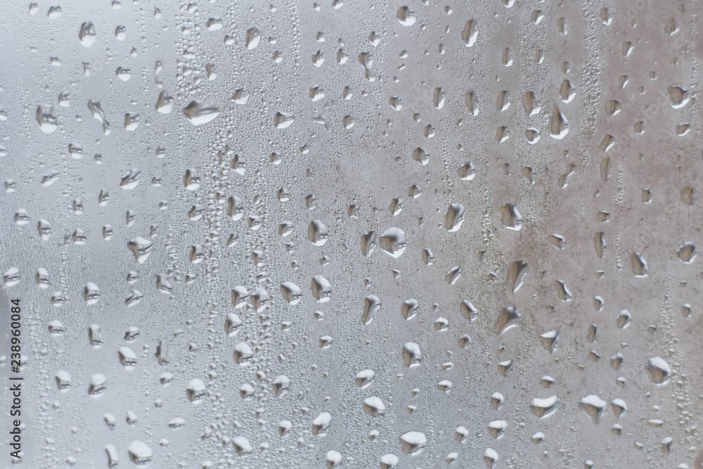Rain drops on the window glass closeup