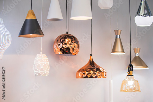 Different modern streamlined mirror copper chandeliers. Bubble metal copper shade pendant photo
