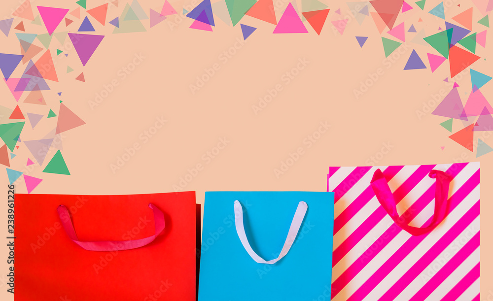 Colourful paper shopping bags on pastel background