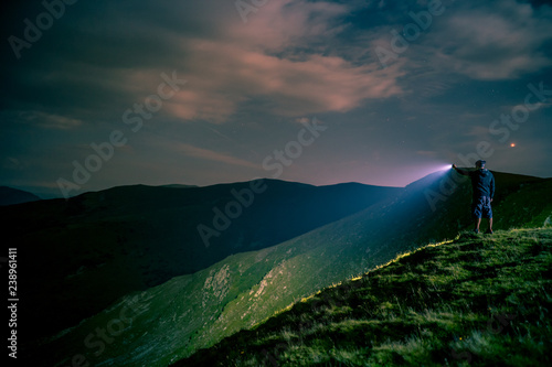 Searching with flashlight in mountains