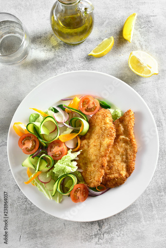 Vegetable salad and breaded chicken breast