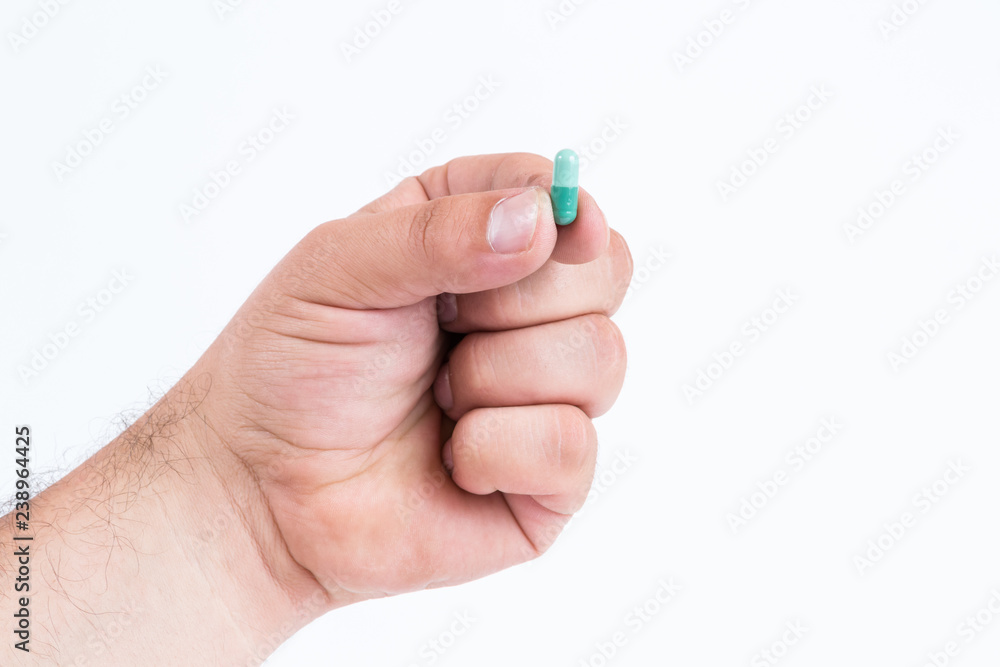 Fototapeta premium Hand holding a pill