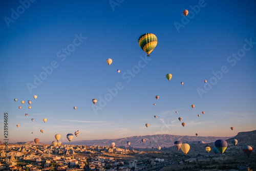 lots colorful balloons in sky above mountains