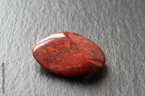 Red jasper stone on a black stone board