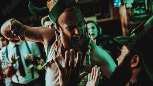 Schilderij op canvas Two Men Fight In Pub. Saint Patrick's Day Concept.