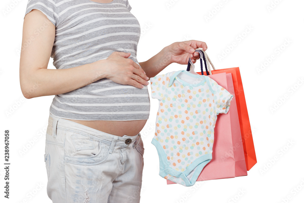 Pregnant woman with various clothes for a newborn Pregnant woman with various clothes for a newborn