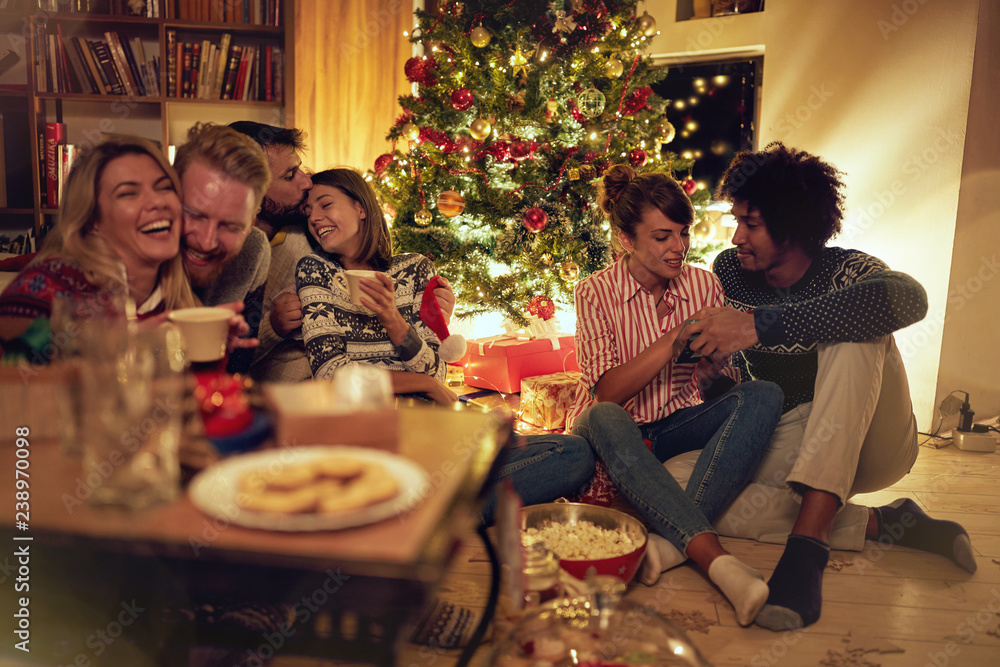 cheerful friends celebrating on Christmas Party at home. cheerful friends celebrating on Christmas Party at home.