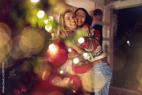 female friends hugging and celebrating Christmas.