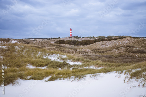 Lighthouse in a dunes landscape in in Amrum Germany.