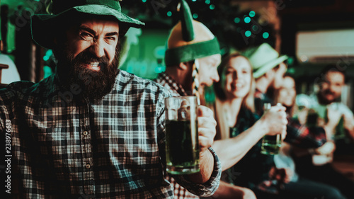 Guy In The Leprechaun Cap Is Drinking A Beer.