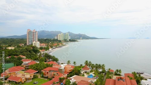 Aerial shot of beautiful condo, pool, jungle, mountain, volcano, villas. photo