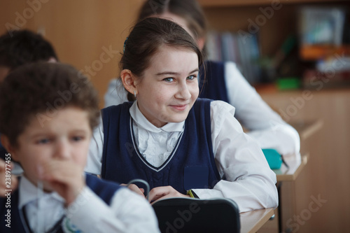 Schoolchildren sit at their desks in the classroom during school hours.