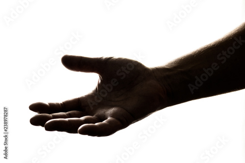 Silhouette of hand reaching out to give, or to receive help/money/hope/gift.