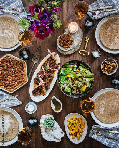 Tablescape with lamb, spring salad, golden beets, mixed drinks, and pecan pie photo