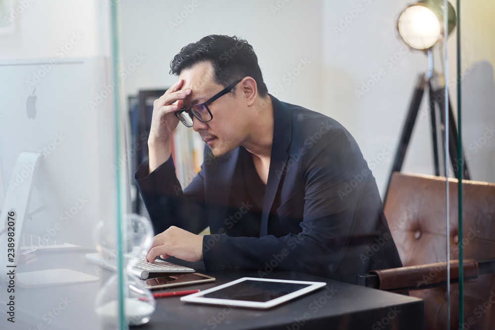 Stressed asian man or businessman at office, failure and headache concept Stressed asian man or businessman at office, failure and headache concept