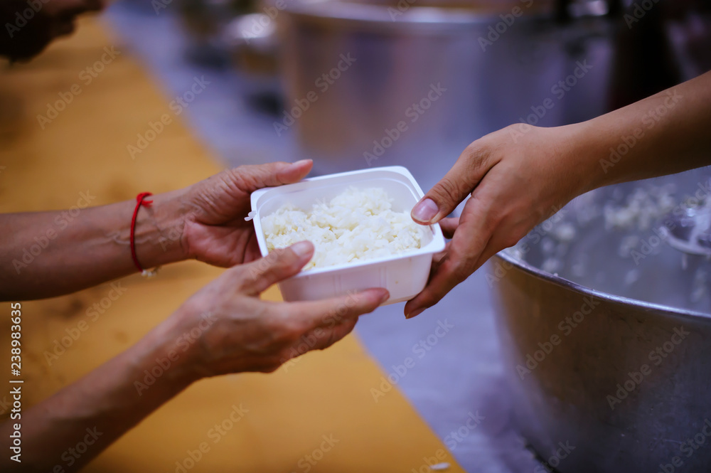 The hands of beggars receive donated food as a share in society : the concept of hunger
