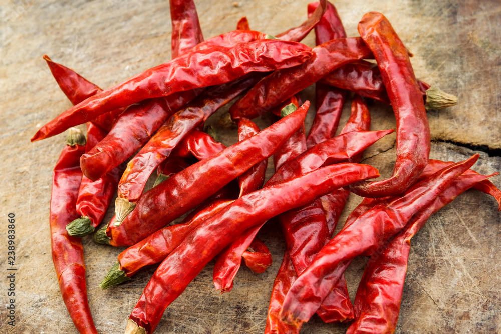 dried red chili on wooden / pile of dry red chilli peppers on old wood