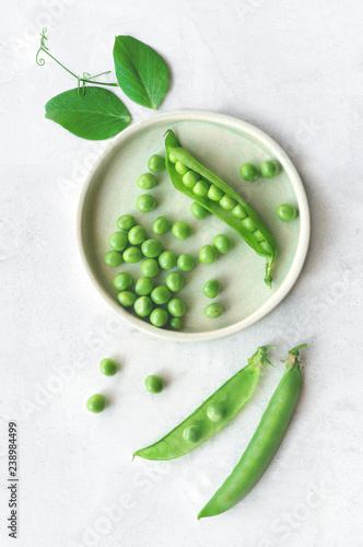 Isolated sweet green peas. Top view. Vertical photo. 
