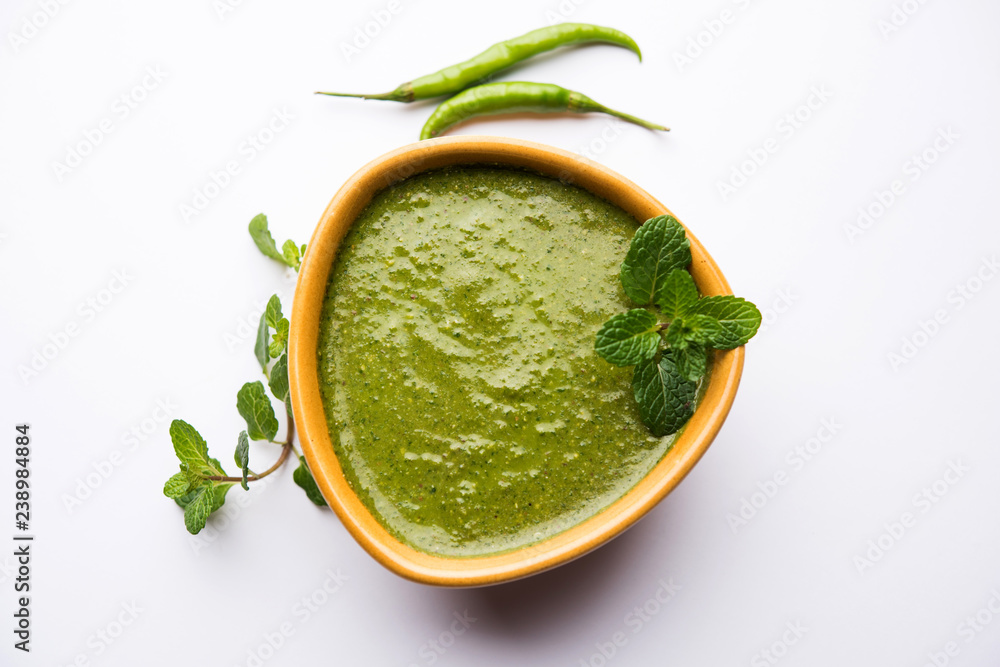Healthy Green Mint Chutney Made with Coriander, pudina And Spices. isolated moody background. selective focus Healthy Green Mint Chutney Made with Coriander, pudina And Spices. isolated moody background. selective focus