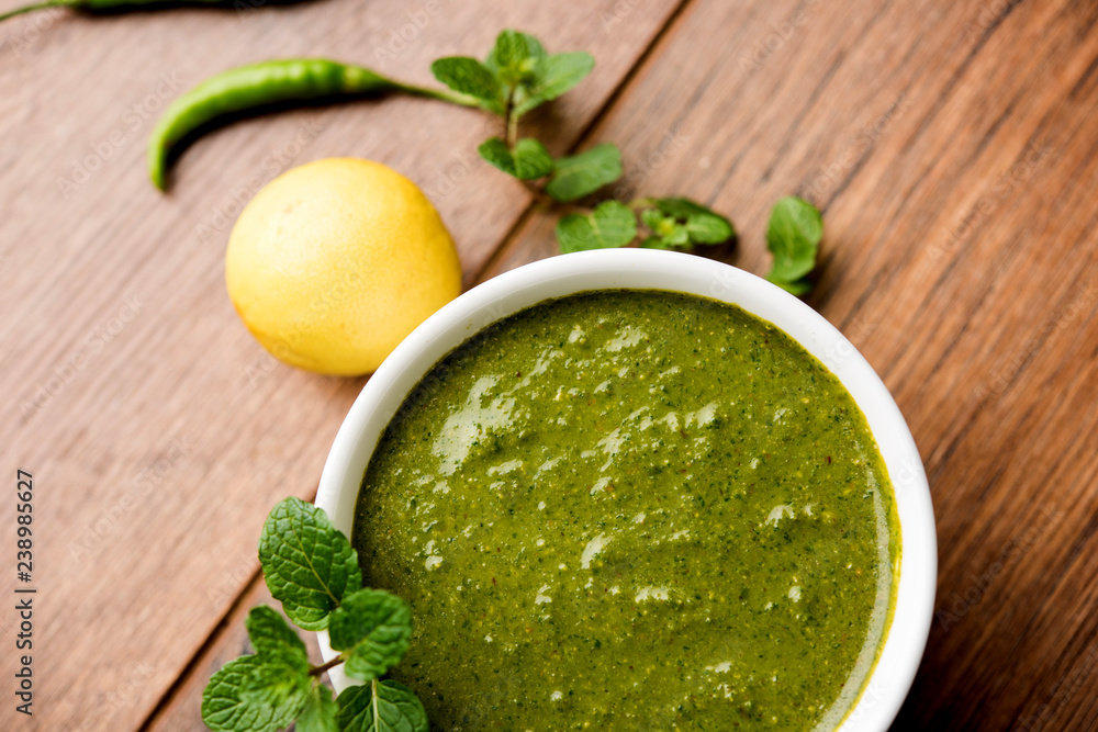 Healthy Green Mint Chutney Made with Coriander, pudina And Spices. isolated moody background. selective focus Healthy Green Mint Chutney Made with Coriander, pudina And Spices. isolated moody background. selective focus