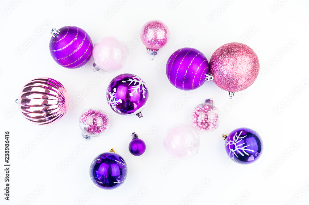 Gentle pink and purple baubles on a white background. Christmas mood. Gentle pink and purple baubles on a white background. Christmas mood.