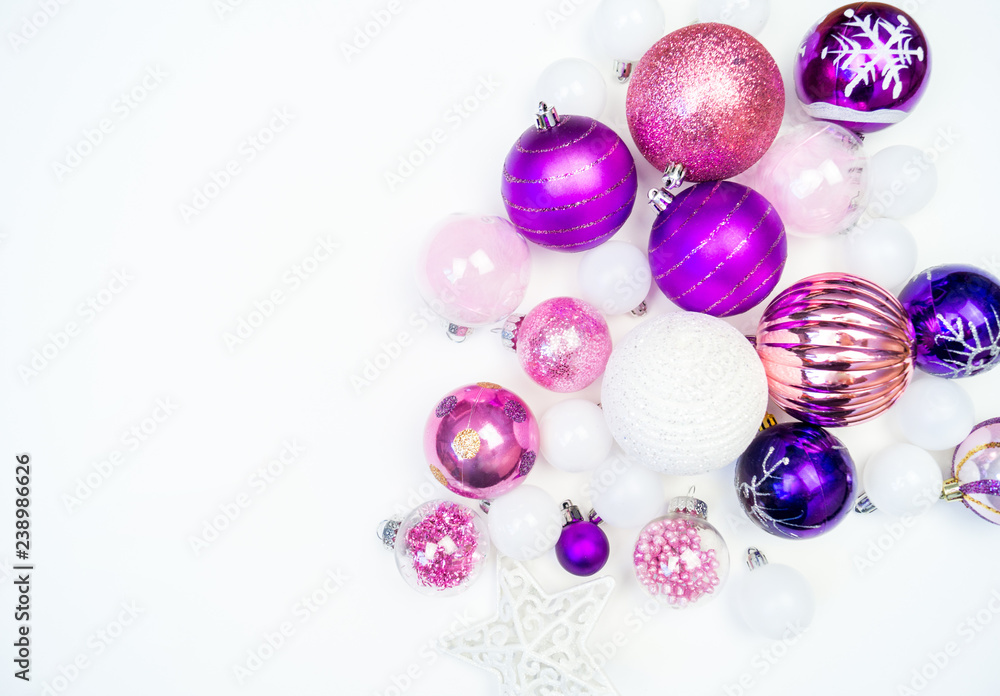 Gentle pink and purple baubles on a white background. Christmas mood. Copy space Gentle pink and purple baubles on a white background. Christmas mood. Copy space