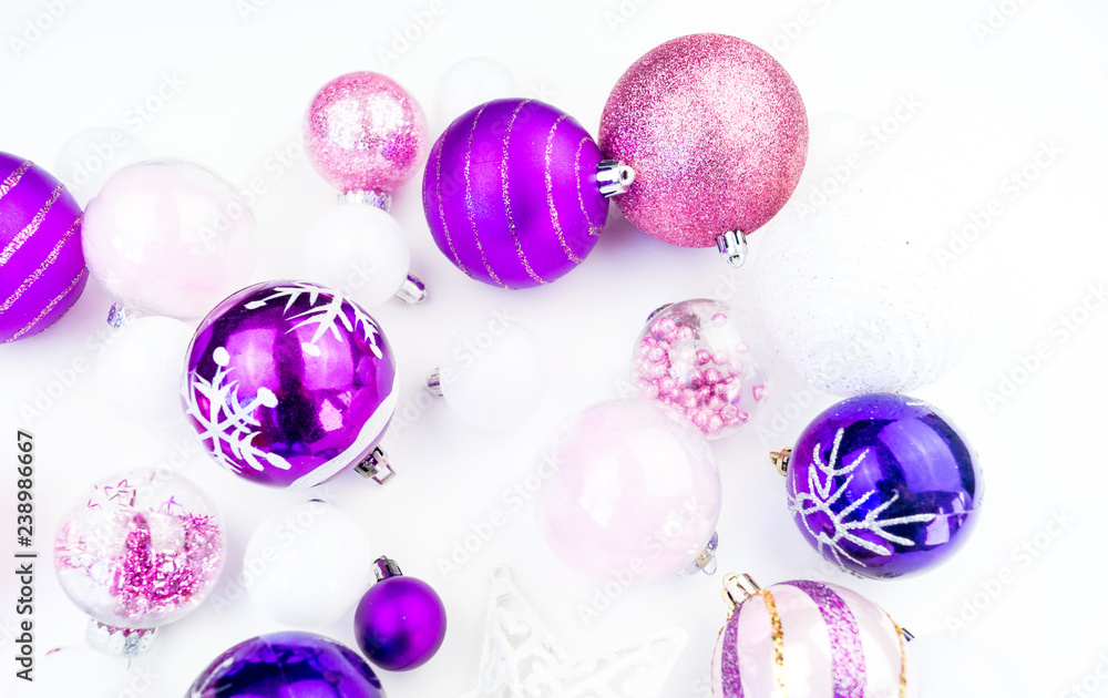 Gentle pink and purple baubles on a white background. Christmas mood. Gentle pink and purple baubles on a white background. Christmas mood.