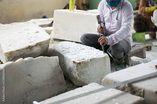 senior sculptor hands working on his marble sculpture in his workshop