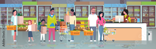 retail woman cashier at checkout supermarket mix race customers holding basket with food standing line queue shopping concept grocery market interior flat horizontal