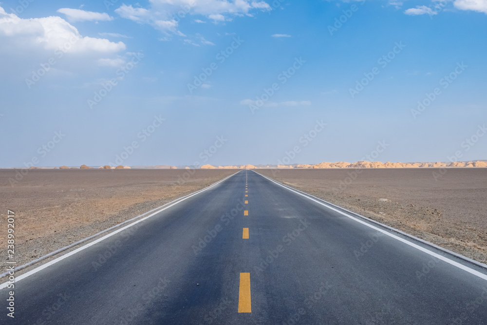 Naklejka premium Car traveling on road in gobi desert in Dunhuang Yardang National Geopark, Gansu, China