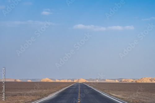 Empty two-lane road in gobi desert in Dunhuang Yardang National Geopark, Gansu, China photo