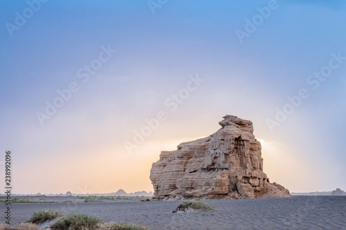 Huge yardang rock in gobi desert against sunset in Dunhuang Yardang National Geopark, Gansu, China photo