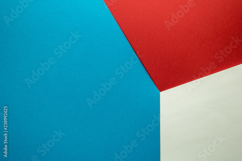 background of three colored sheets of paper