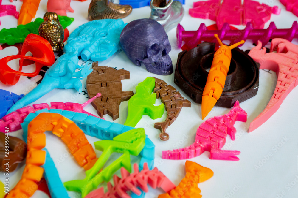 Models printed by 3d printer. Bright colorful objects printed on a 3d printer on a table close-up. Fused deposition modeling, FDM. Concept modern progressive additive technology for 3d printing.