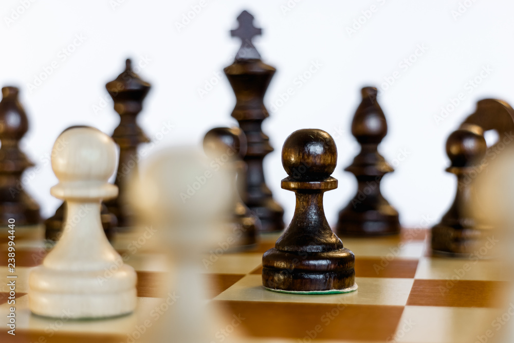 Chess set on chessboard focus on black pawn Chess set on chessboard focus on black pawn