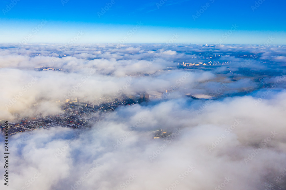 Clouds above the city. Beautiful aerial landscape