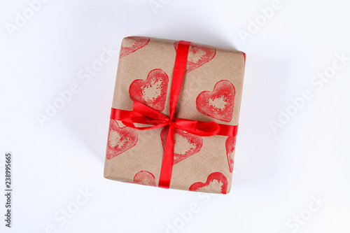 Diy. Gift wrapping for Valentine's Day. Kraft paper gift and potato stamp in the shape of a heart and red paint do it yourself on February 14th. Top view on a white background. step by step. © detry26