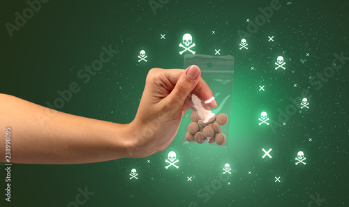 Female handing over pills with skull concept  photo