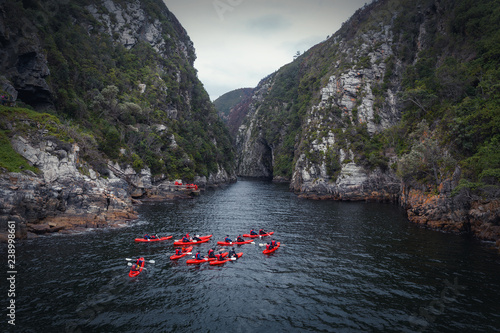 Group kayaking in river canyon in Knysna, South Africa