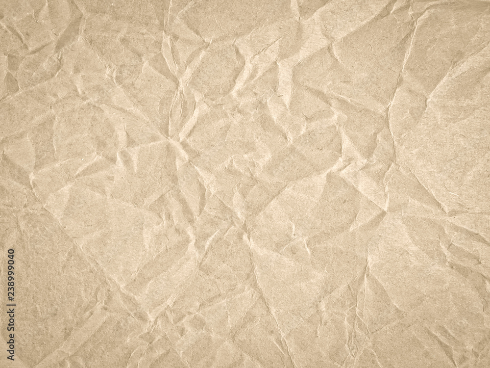Fototapeta premium Texture of beige crumpled craft paper. Texture for design, abstract background