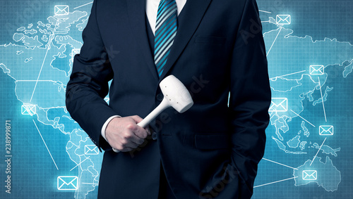 Businessman holding tool with global map graphic on the background photo