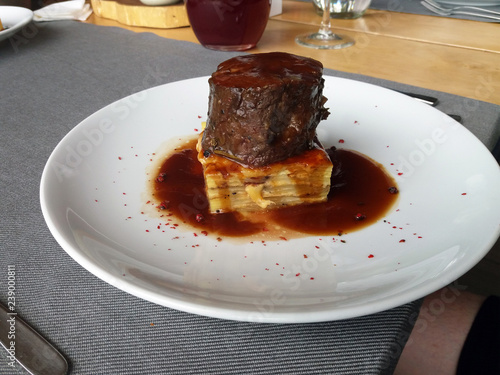 Beef medallion with potato lasagna. European cuisine.