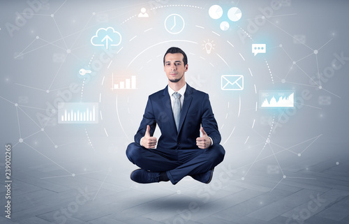 Elegant calm businessman levitates in yoga position with data circulation concept  