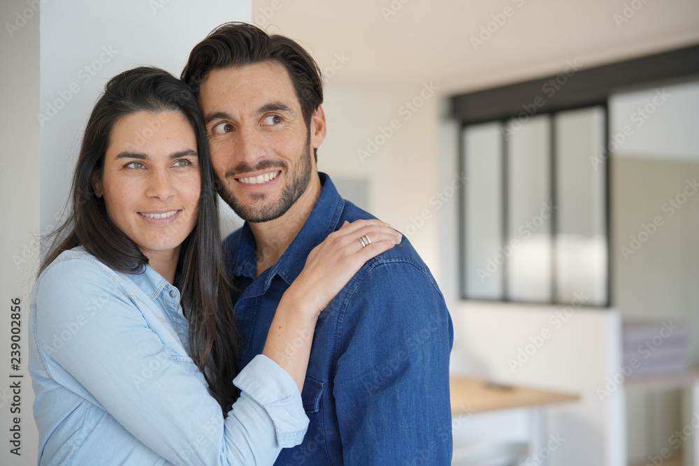 Portrait of attractive loving couple in contemporary home Portrait of attractive loving couple in contemporary home